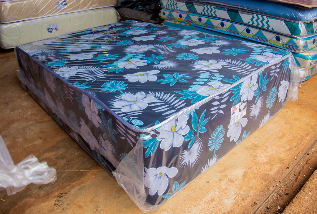 Angled view of a floral-pattern mattress on display