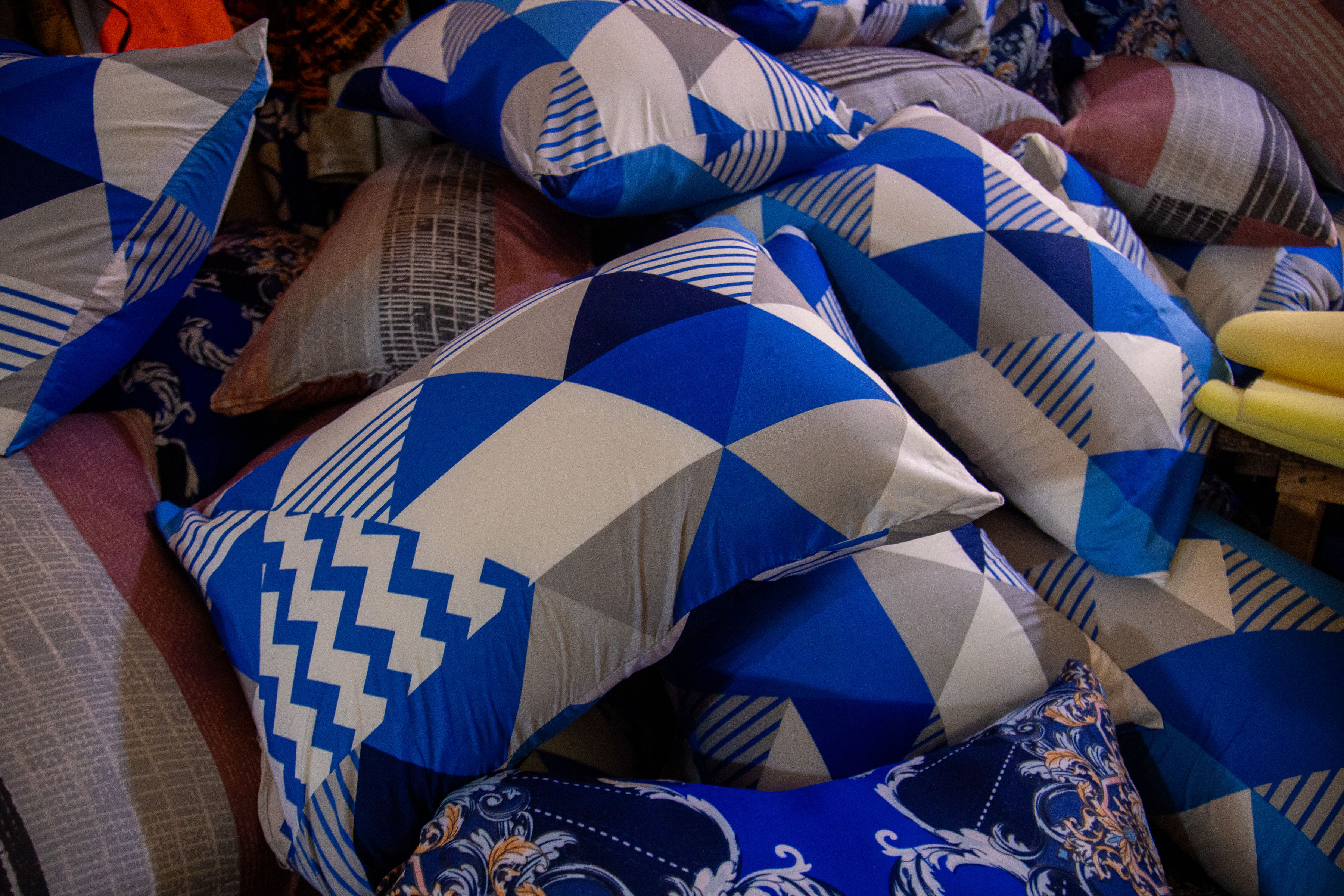 Blue patterned pillows and bedding accessories displayed together