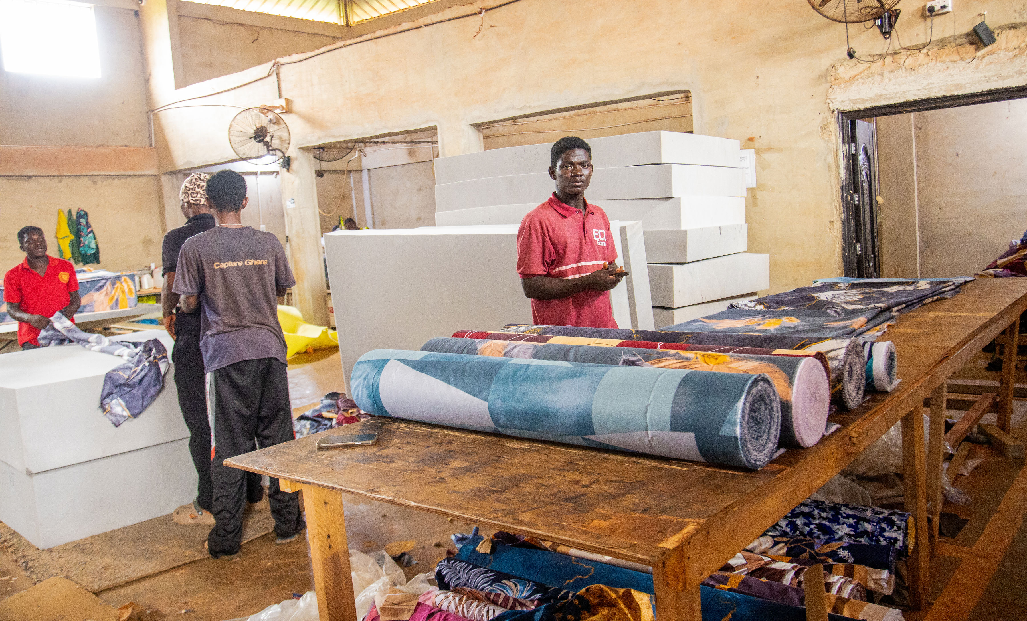Workers and mattress materials inside the Extra Comfort production space