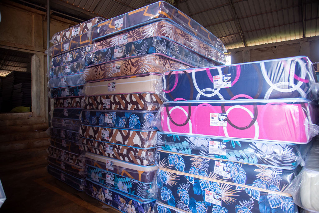 Stacked patterned orthopedic mattresses displayed in the showroom