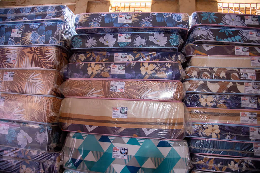 Orthopedic mattress range arranged in layered showroom stacks